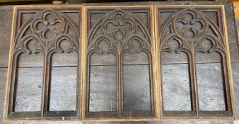 Three rectangular pierced oak gothic style panels, each width 28cm, height 45cm