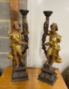 A pair of 18th century style carved pine parcel gilt figural lamp bases, height 75cm