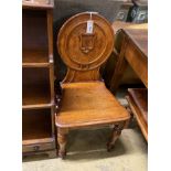 A Victorian oak hall chair