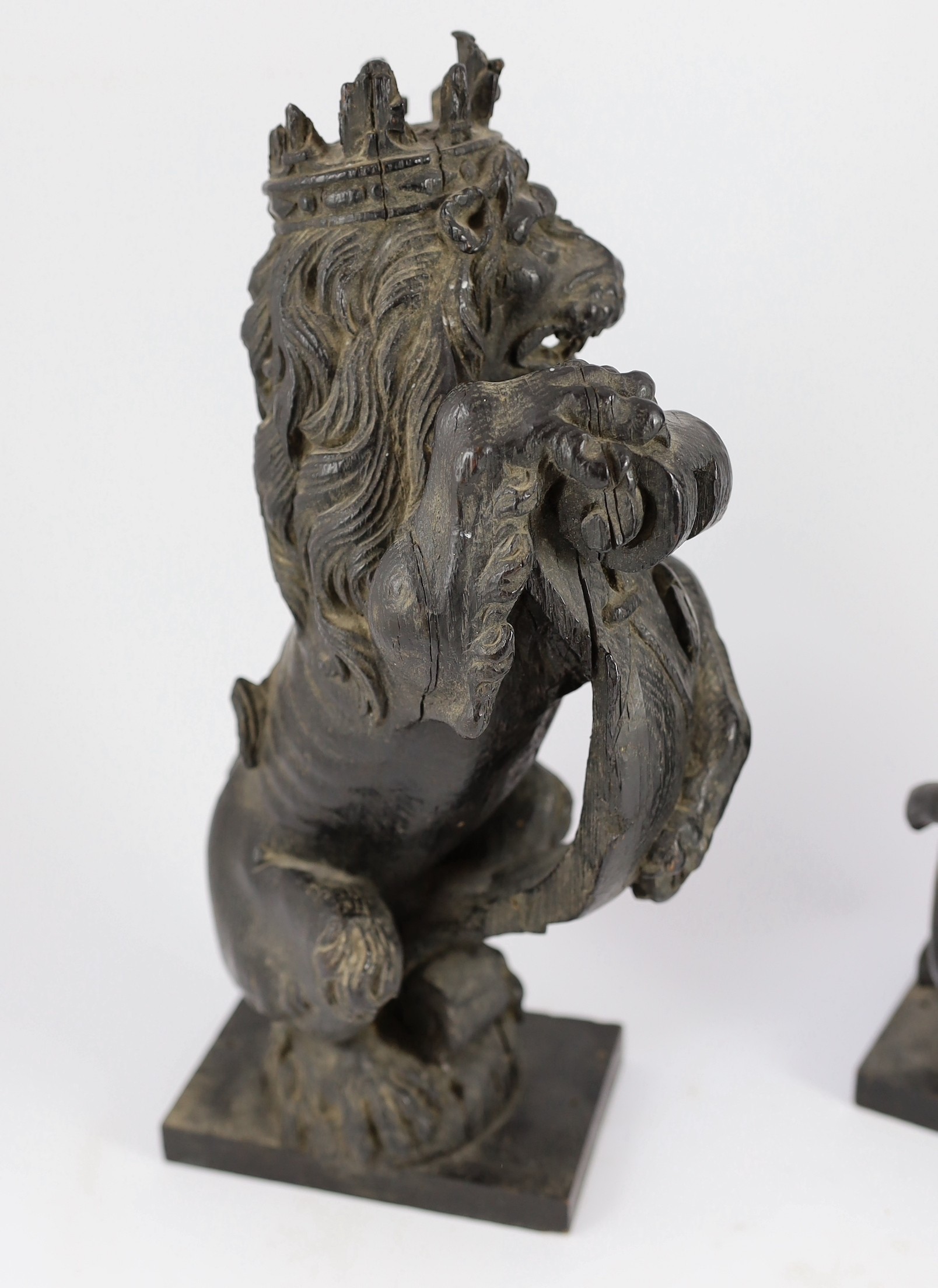 A pair of 18th century carved and ebonised oak heraldic beasts, lion and unicorn, each holding - Bild 3 aus 6