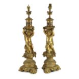 A pair of Victorian style ormolu table lamps, each with bacchic putto stem, on scroll feet, 50cm