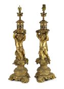 A pair of Victorian style ormolu table lamps, each with bacchic putto stem, on scroll feet, 50cm