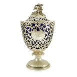 A Victorian pierced silver urn shaped pedestal vase and cover, by Reily & Storer, with blue glass