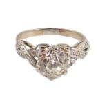 A mid 20th century white gold and single stone diamond ring, with diamond set crossover shoulders,