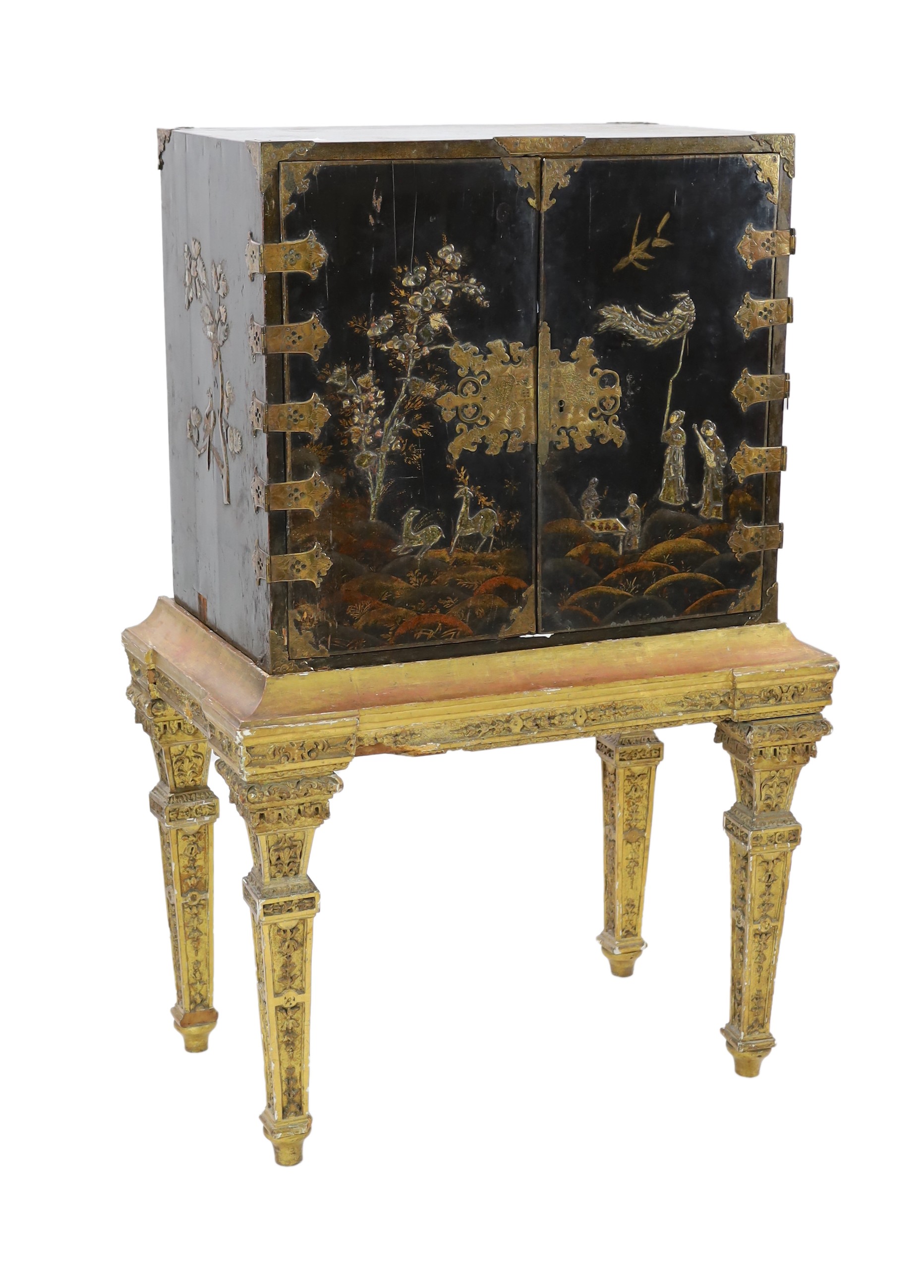 A William & Mary black japanned cabinet on stand, the two door cabinet with original gilt brass