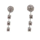 A modern pair of 18ct white gold, diamond cluster and three stone diamond drop set earrings, 28mm,