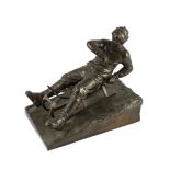A late 19th / early 20th century German bronze model of a tobogganist, on naturalistic base,