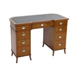 An Edwardian painted satinwood kneehole desk, with concave front and bowed back and decorated in the