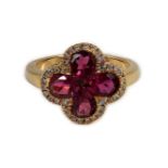 A modern 18k gold four stone pear shaped pink tourmaline set dress ring with diamond chip set