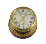 J.W. Benson of London. A brass bulkhead timepiece for HMS Dunnottar Castle, with silvered dial and