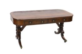 A Regency mahogany library table, with rounded rectangular top, two long and two dummy drawers, on
