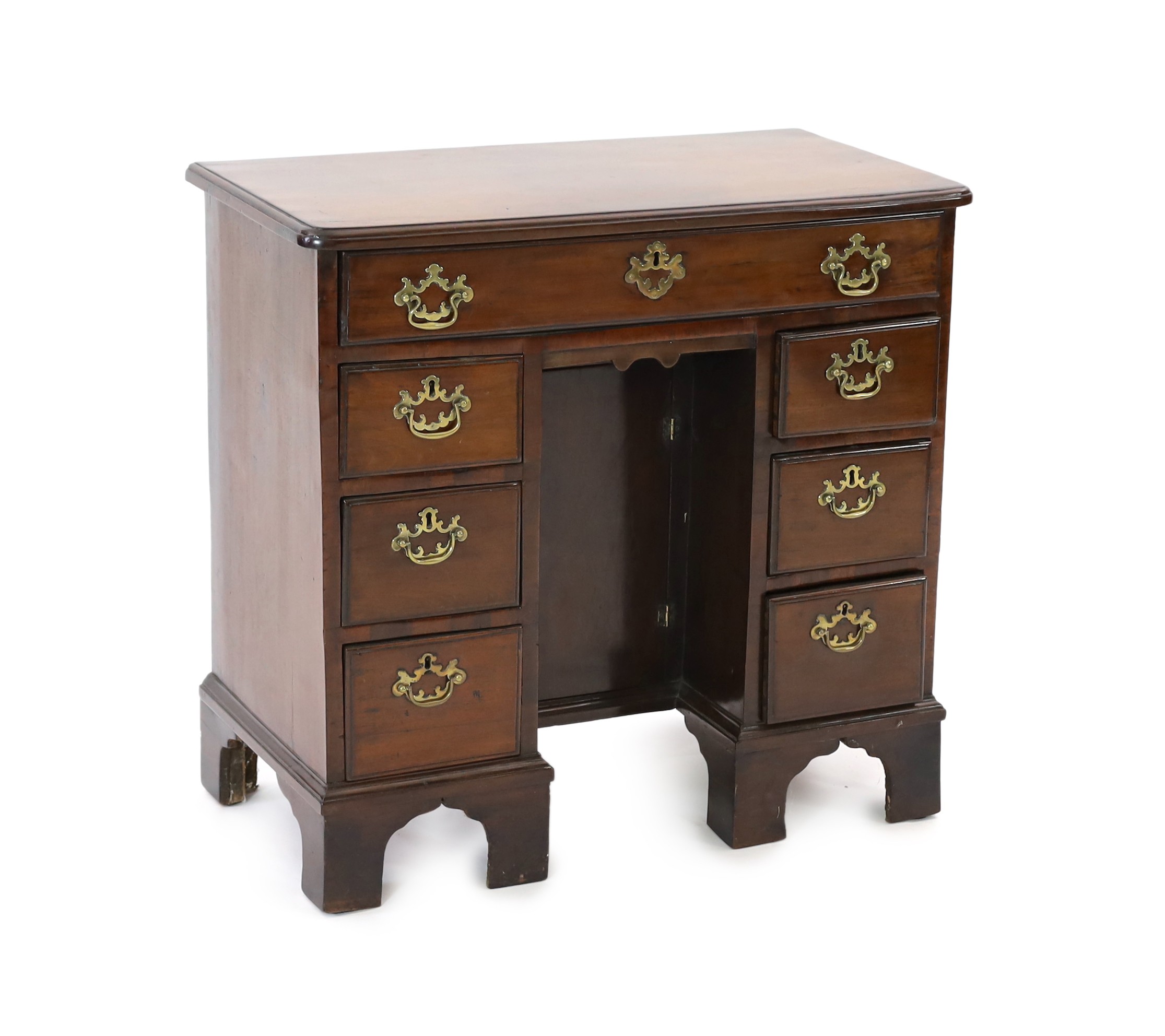 A George III mahogany kneehole desk, fitted six drawers around a central recessed cupboard, on