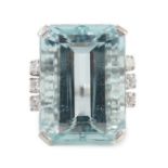 A large modern 14k white gold and emerald cut aquamarine set dress ring, flanked by six round cut
