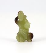 A Chinese yellow and brown jade figure of a man seated on a creature, 19th century, the greenish