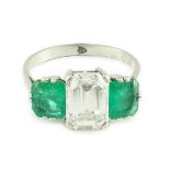 A mid 20th century platinum, single stone emerald cut diamond and two stone emerald set dress