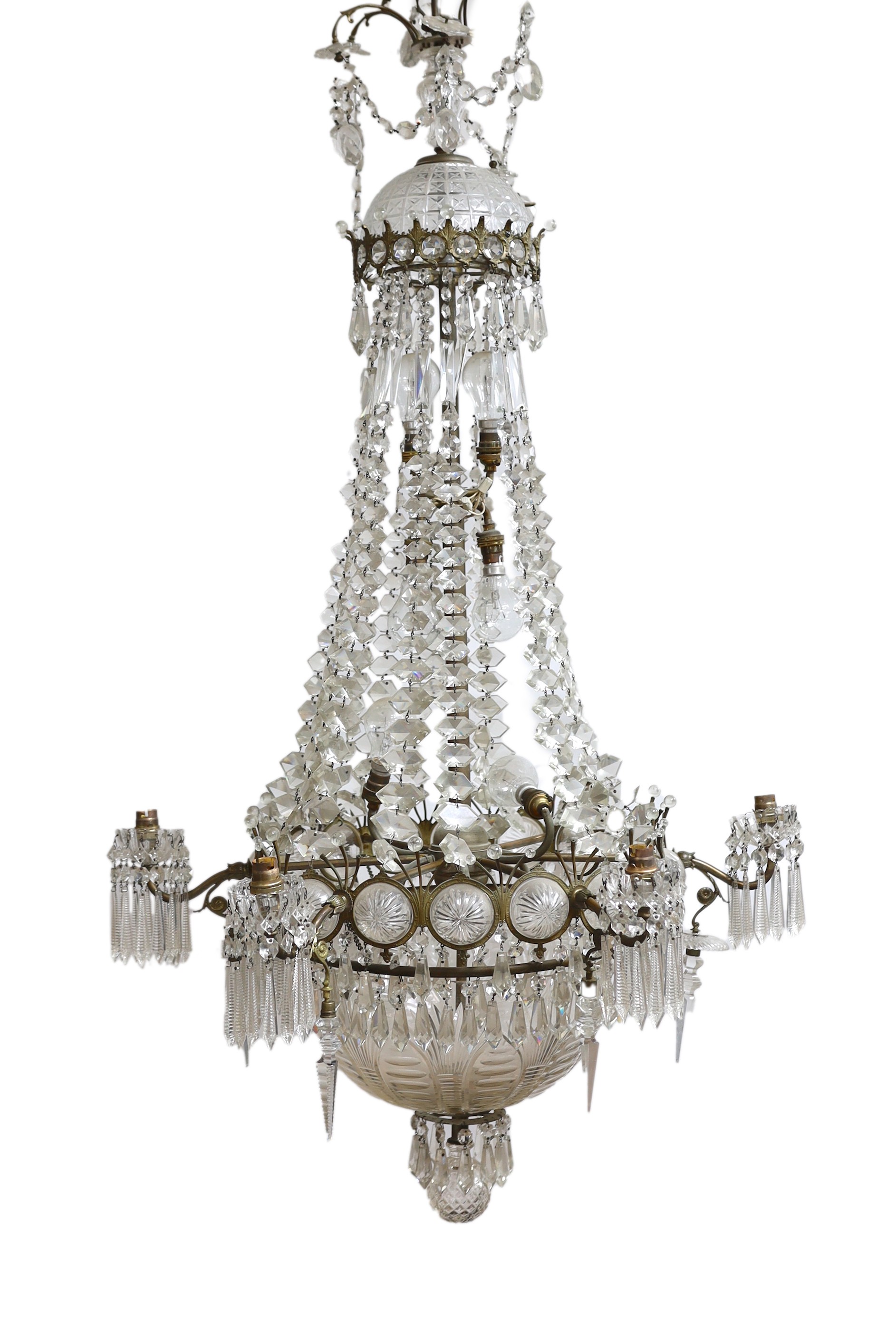 An Edwardian cut glass chandelier, with swagged top and lozenge shaped drops sweeping down to the