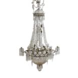 An Edwardian cut glass chandelier, with swagged top and lozenge shaped drops sweeping down to the