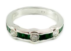 A modern 18ct white gold, square cut emerald and round cut diamond set half eternity ring, size L/M,