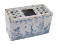 An English delftware flower brick, mid 18th century, painted with Chinese figures in European
