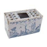 An English delftware flower brick, mid 18th century, painted with Chinese figures in European