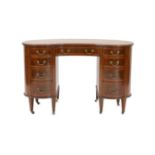 An Edwardian satinwood banded mahogany kidney shaped kneehole desk, with brown skiver and