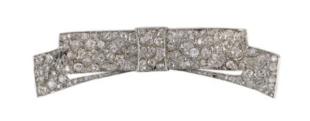 A mid 20th century white gold and pave set diamond ribbon bow brooch, the stones in an abstract