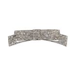 A mid 20th century white gold and pave set diamond ribbon bow brooch, the stones in an abstract