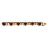 A 20th century Dutch 14k gold and six stone facet cut cabochon garnet set fancy link bracelet, 19cm,