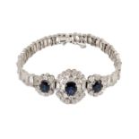 A mid to late 20th century textured 18k white gold, sapphire, round and baguette cut diamond set