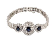 A mid to late 20th century textured 18k white gold, sapphire, round and baguette cut diamond set
