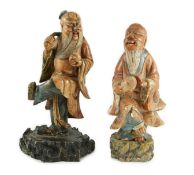 Two Chinese soapstone figures of Shou Lao, 18th century, each figure holding a peach and standing on