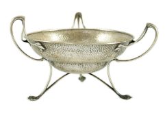 An Edwardian Art Nouveau planished silver tri-handled bowl by The Alexander Clark Manufacturing Co.,