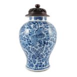A Chinese blue and white ‘phoenix and peony’ baluster jar, Kangxi period, with a later wood cover,