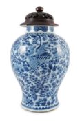 A Chinese blue and white ‘phoenix and peony’ baluster jar, Kangxi period, with a later wood cover,