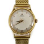 A gentleman's 1950's 18ct gold Omega Automatic wrist watch, with French 18ct gold mark, on an