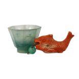 A Chinese jadeite small cup and a coral 'fish' pendant, 19th/20th century, the octagonal cup with