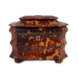 A Regency blond tortoiseshell sarcophagus shaped tea caddy, of octagonal form, with ivory inner