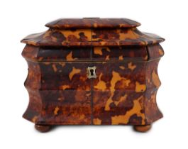 A Regency blond tortoiseshell sarcophagus shaped tea caddy, of octagonal form, with ivory inner