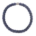 An 18K white gold and synthetic sapphire? flower head cluster set necklace, gross weight 65