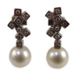 A modern pair of 18ct white gold, single stone South Sea pearl and eight stone diamond cluster set