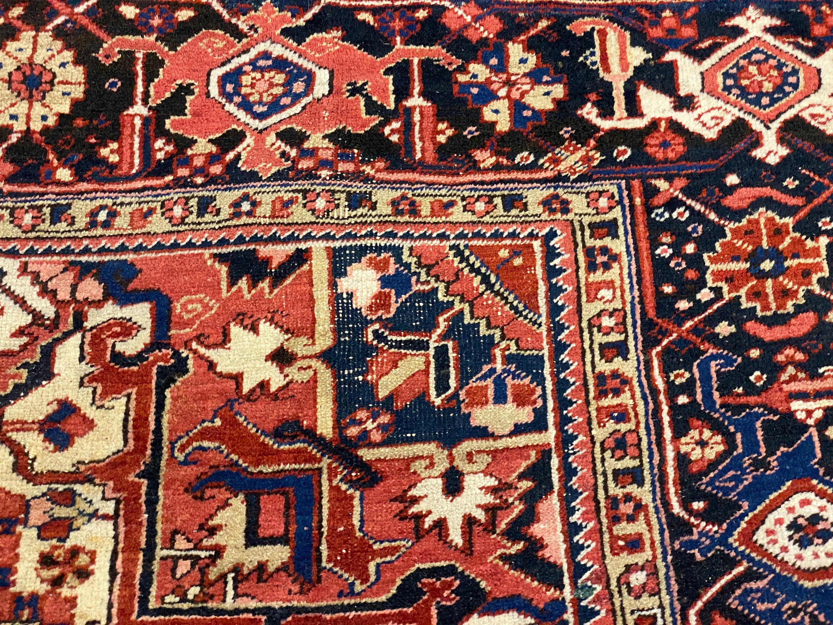 An Heriz red ground carpet, with a lobed central medallion within a floral field and wide conforming - Image 6 of 7