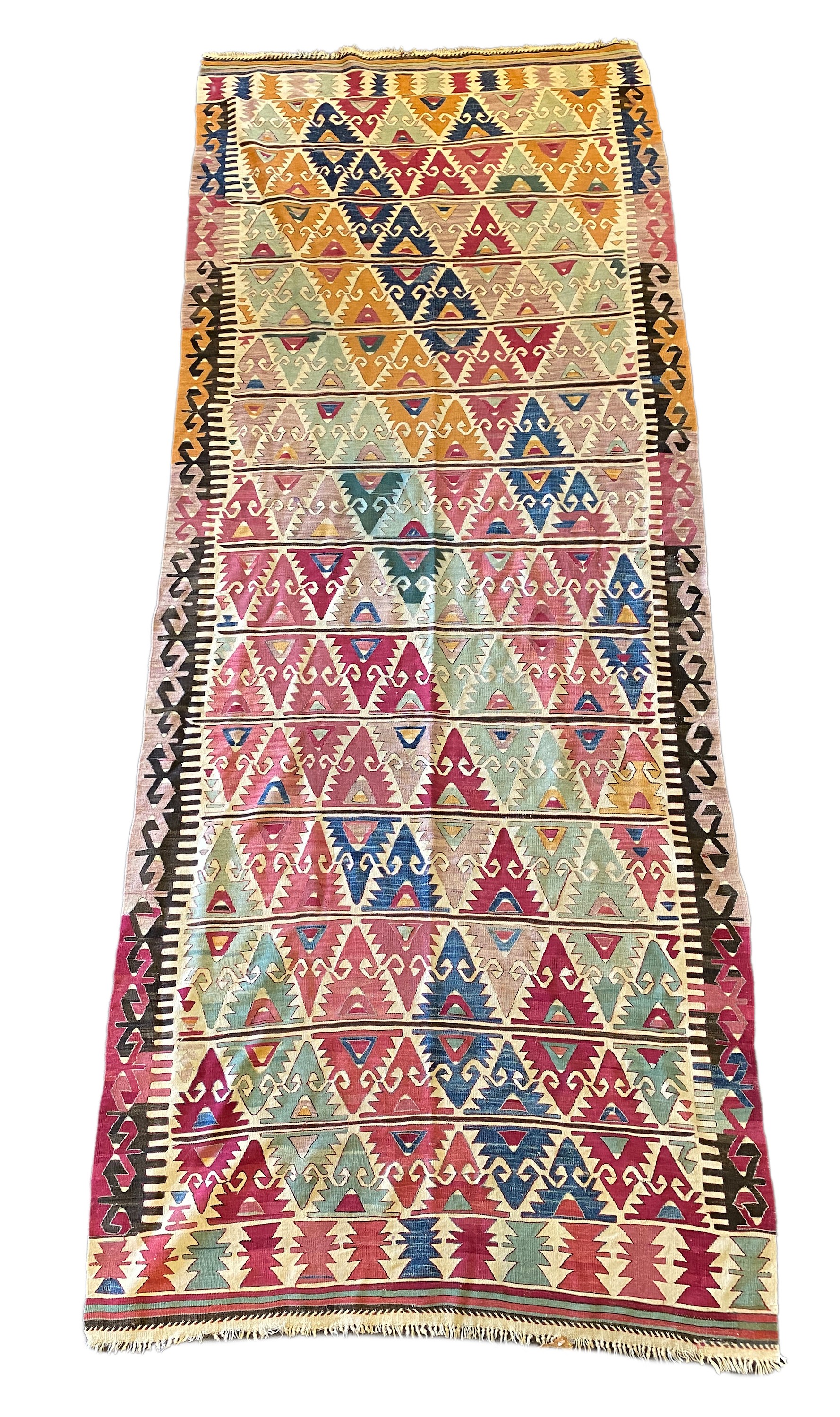 An Anatolian Kilim flatweave polychrome hall carpet, woven with rows of stylised hooked devices, 410