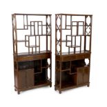 A pair of Chinese jichimu display cabinets, each with asymmetrical open shelves above two drawers,
