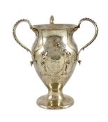 A George V Arts and Crafts planished silver three handled pedestal vase, by Holland, Aldwinckle &