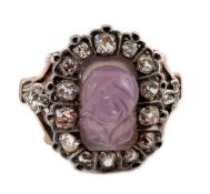 A 19th century gold, carved amethyst and diamond cluster set dress ring, the stone carved with a