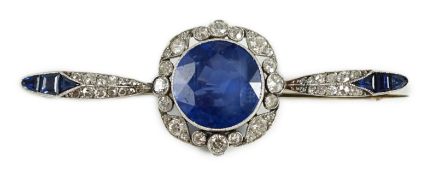An early 20th century French platinum, sapphire and diamond bar brooch, the central round cut
