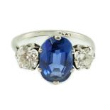 A mid 20th century platinum, single stone oval cut sapphire and two stone cushion cut diamond set