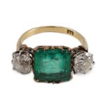 An early 20th century 18ct gold, square cut single stone emerald and two stone cushion cut diamond