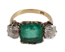 An early 20th century 18ct gold, square cut single stone emerald and two stone cushion cut diamond