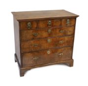 A George II crossbanded walnut chest, of three short and three graduated long drawers, on bracket